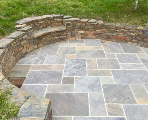 Stone-work seating wall with natural sandstone paving- Earthform